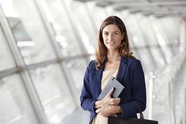 young woman in suit with planner in hand