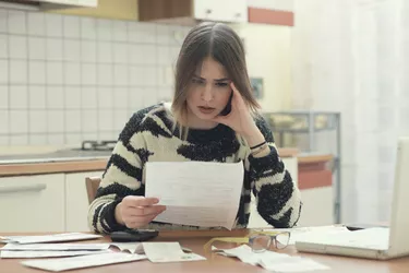 perplexed young woman with paperwork