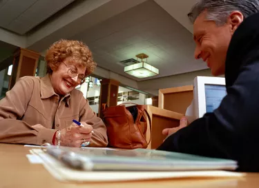 Financial Advisor Assisting Woman with Paperwork