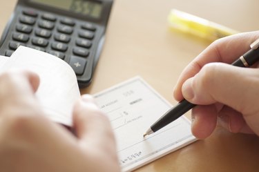 Man prepares to write check