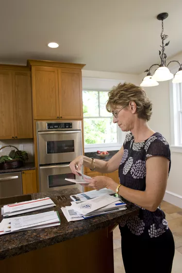 Woman looking through bills 