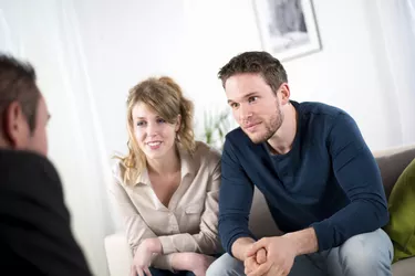 cheerful young couple with a consultant salesman