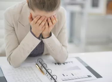 frustrated business woman working with documents in office