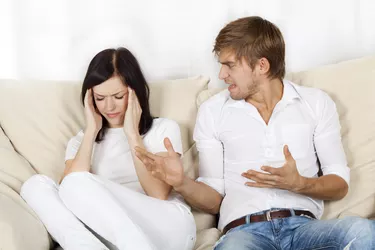 Couple sitting on couch at home