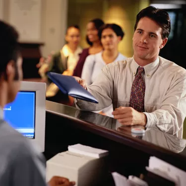 Man Handing a Teller a Pouch of Money