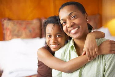 Portrait of mother with daughter in hotel room
