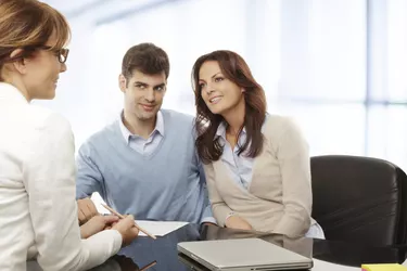 Young couple discussing financial plan with consultat