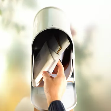 Hand with open mailbox