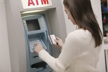Woman using ATM machine