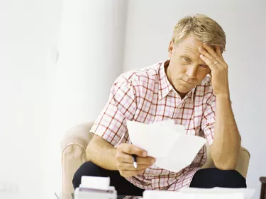 mid adult man holding bills in his hand