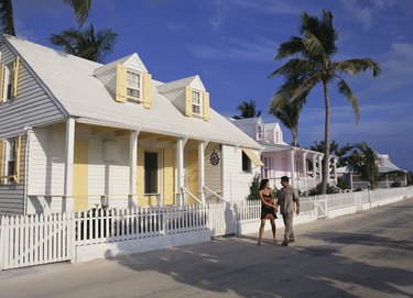 Couple walking by house
