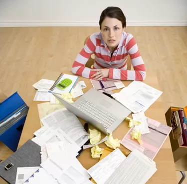 Woman with laptop and paperwork