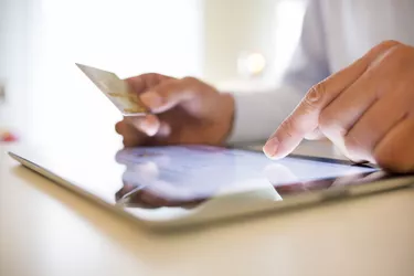 Man using tablet pc and credit card indoor, Shopping online