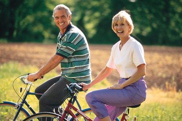 Couple riding bicycles outdoors