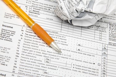 Tax forms with pen