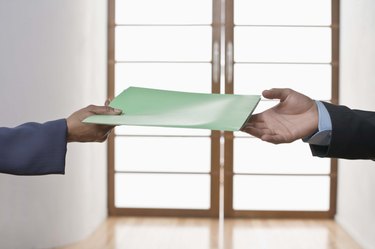 Hands of people exchanging folder