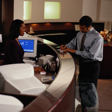 Man Writing a Check at a Bank