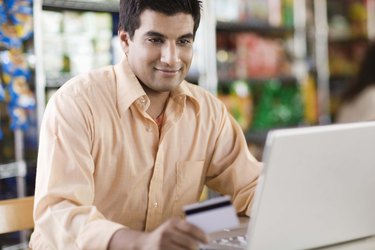 Man using laptop and credit card