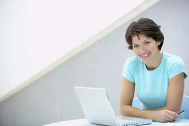 Smiling woman with laptop