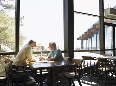 Mature Couple holding hands in restaurant