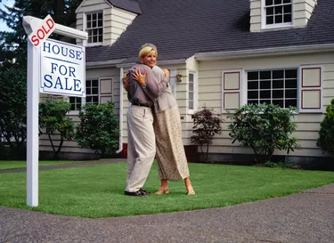 Couple Hugging After Buying a House