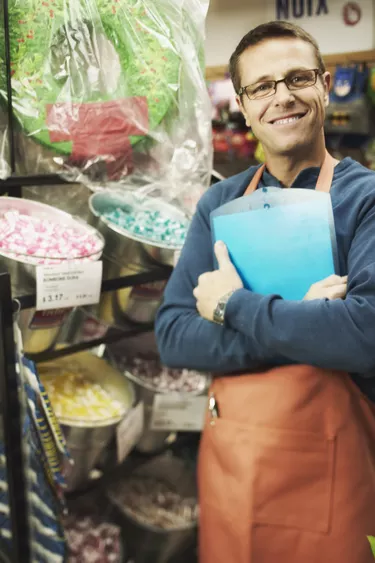 Small business owner standing in candy store