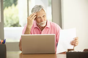 Senior Man Using Laptop At Home