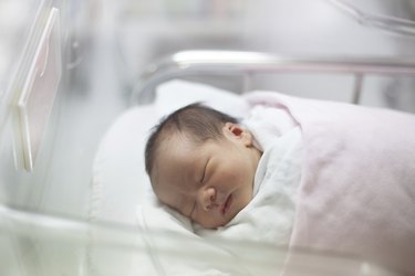 face of first day new born in hospital delivery room