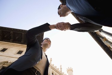 Low angle view of businessmen shaking hands