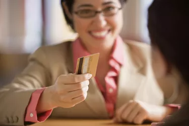 Young woman paying with a credit card