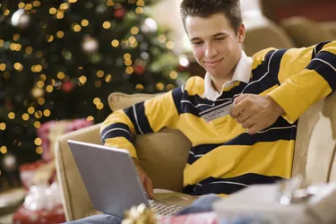 Teenage boy using laptop computer at Christmas