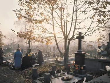 People at burial plot in cemetery