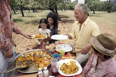 family eating paella outdoors