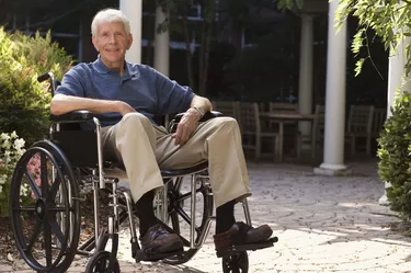 Elderly man in wheelchair outdoors