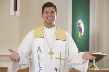 Friendly priest with arms outstretched