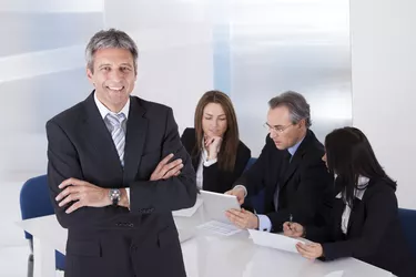 Businessman Standing In Front Of Colleagues