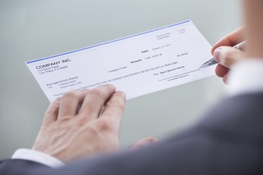 Businessperson Signing Money Cheque