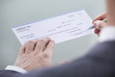 Businessperson Signing Money Cheque