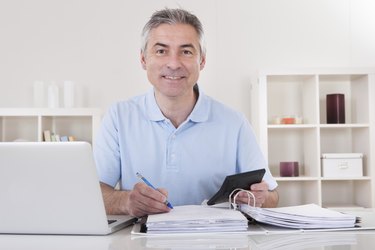 Happy Mature Man Calculating
