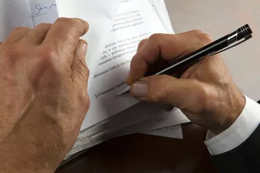 Businessman signs documents