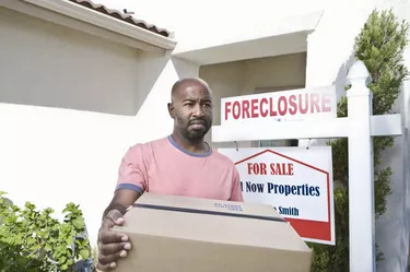 Sad mid adult man moving out of house