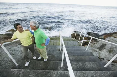 Father and son chatting on seaside steps