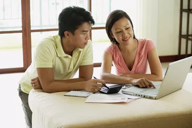 Man and woman doing finances on laptop