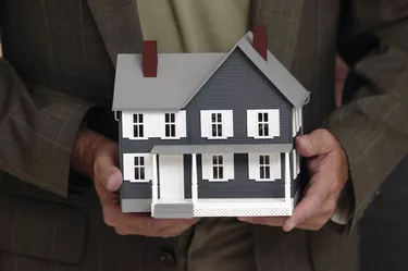 Man holding model house