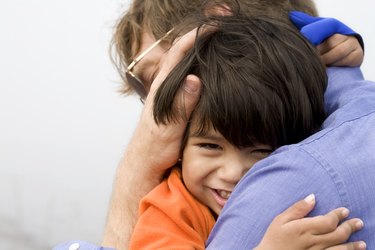 Little boy giving his father a big hug