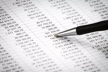 Businessman showing diagram on a financial report using pen