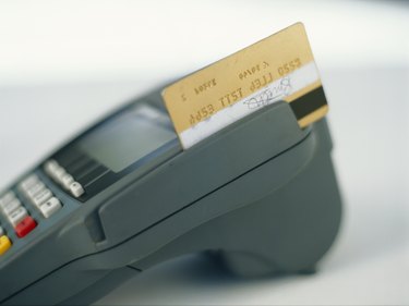 Credit card in credit card reader, close-up
