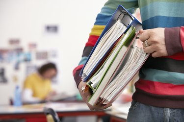Young Man Carrying File Folders
