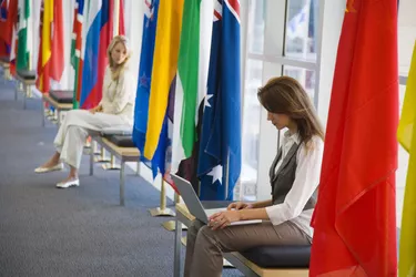 Women with laptop and international flags