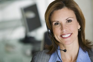 Smiling businesswoman with hands-free headet
